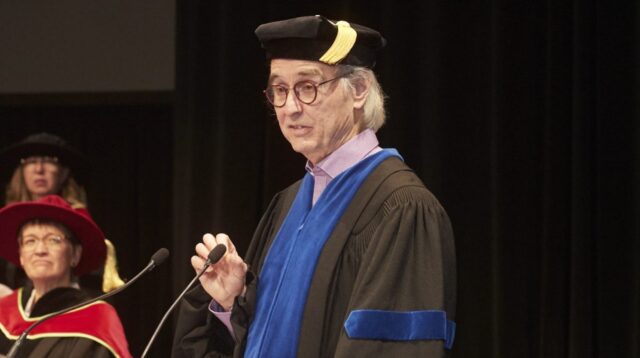 Donald Honourary Degree 5 Man giving a speech at commencement ceremony for university students of Adler University
