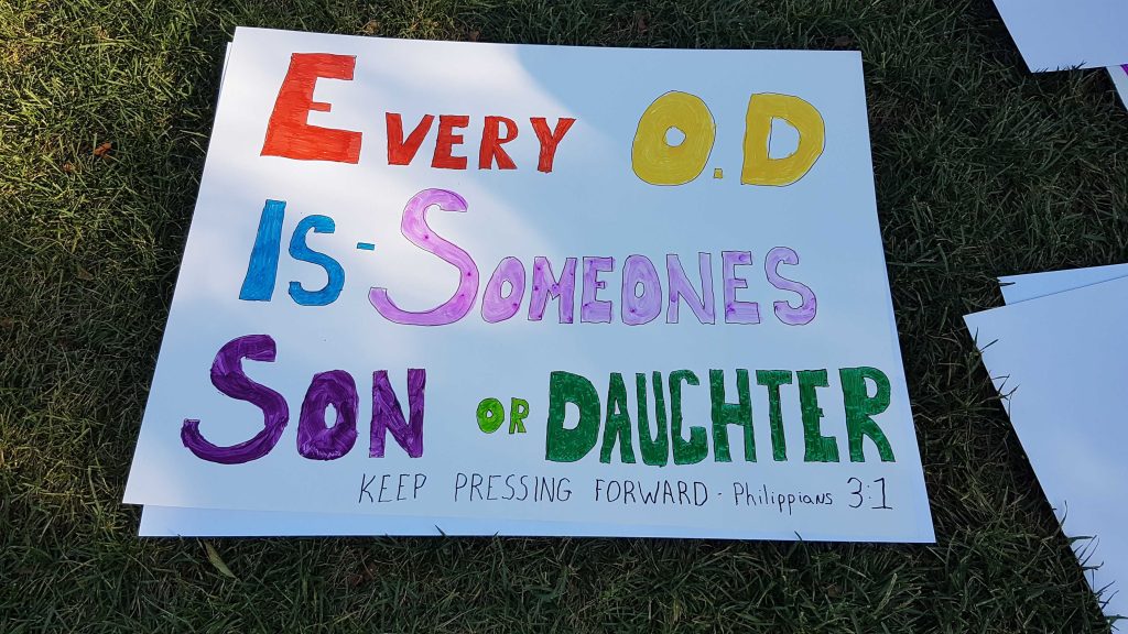 Large sign reading "every OD is someone's son or daughter"