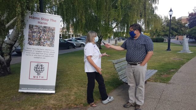 Lethbridge SCS Rally 11 Member of Moms Stop the Harm being interviewed by a reporter