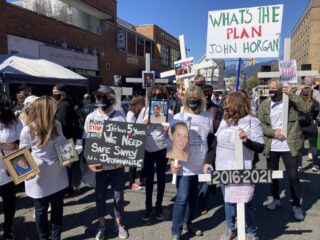 Mothers holding protest signs
