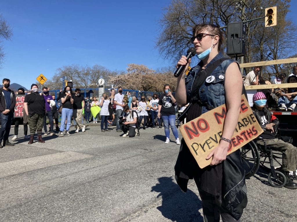 Organizer on a microphone at safe supply rally