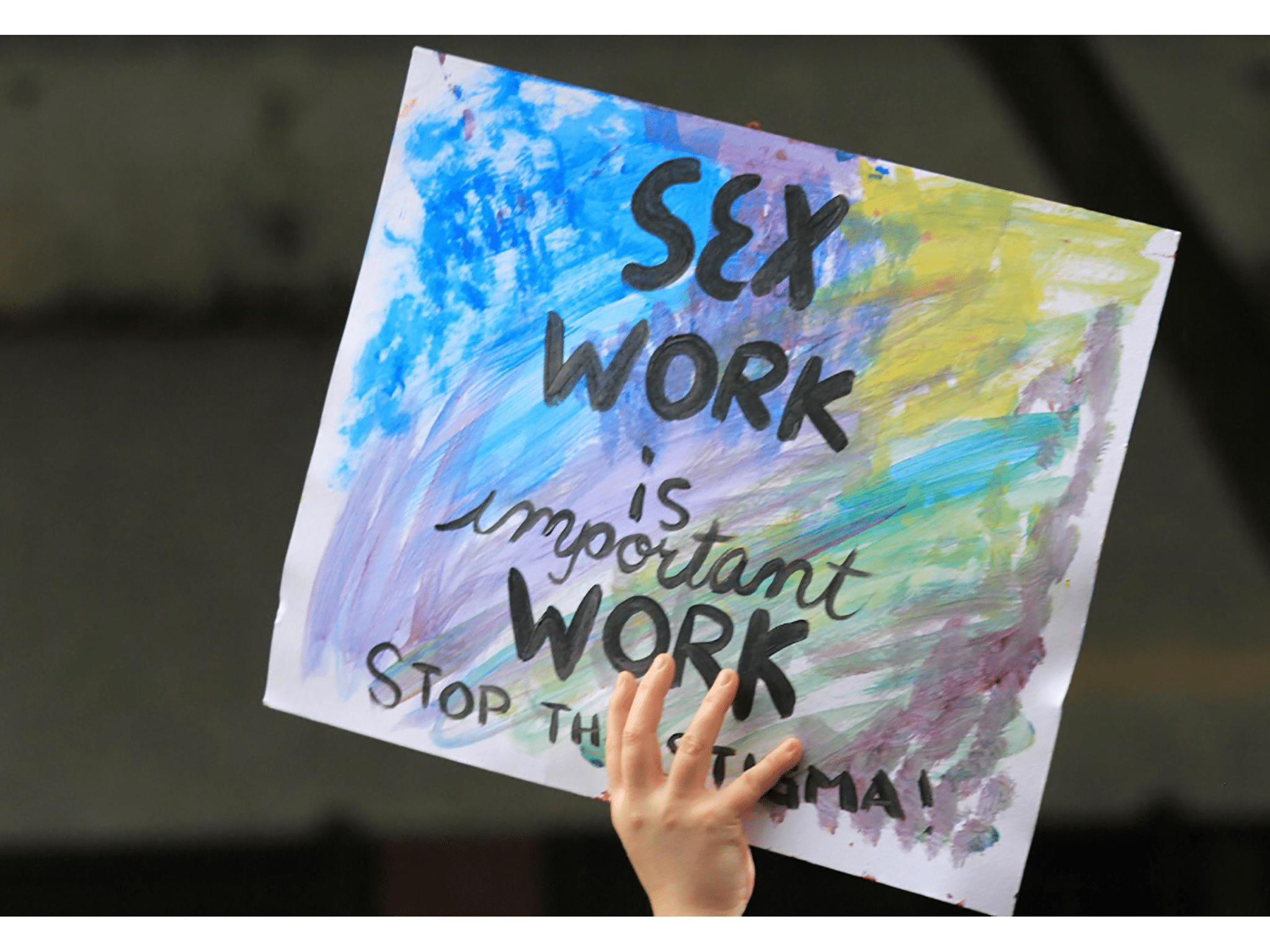 hand holding a sign in support of sex work