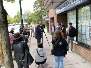 A crowd of people speaking to the media