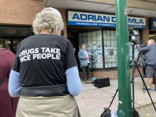 A person speaking at a microphone at a press conference