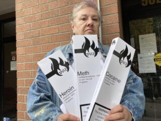 A person holding three boxes