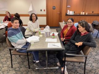 Four members of CDPC seated at a table during a group exercise